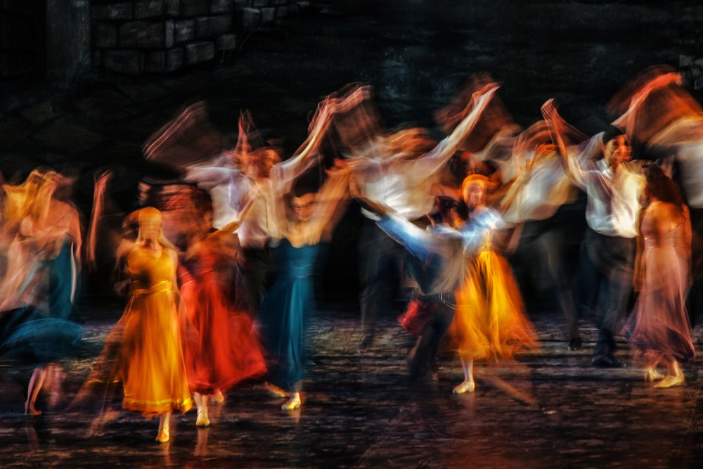 blurred image of people performing on a stage
