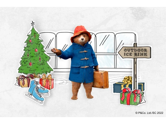 paddington bear with a christmas tree and an ice skating sign