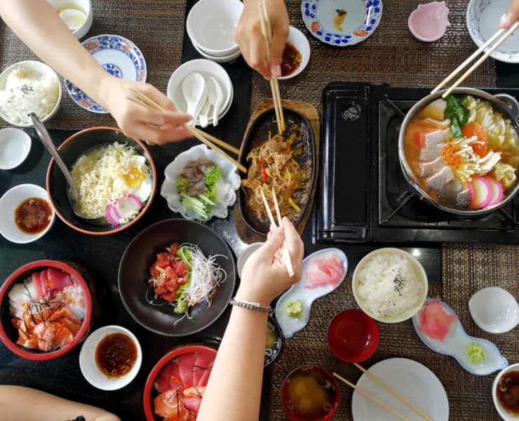 people sharing a sushi takeaway