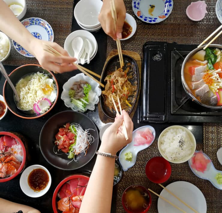 people sharing a sushi takeaway