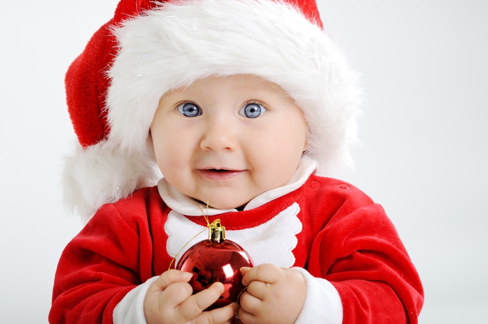 a baby dressed in a santa outfit