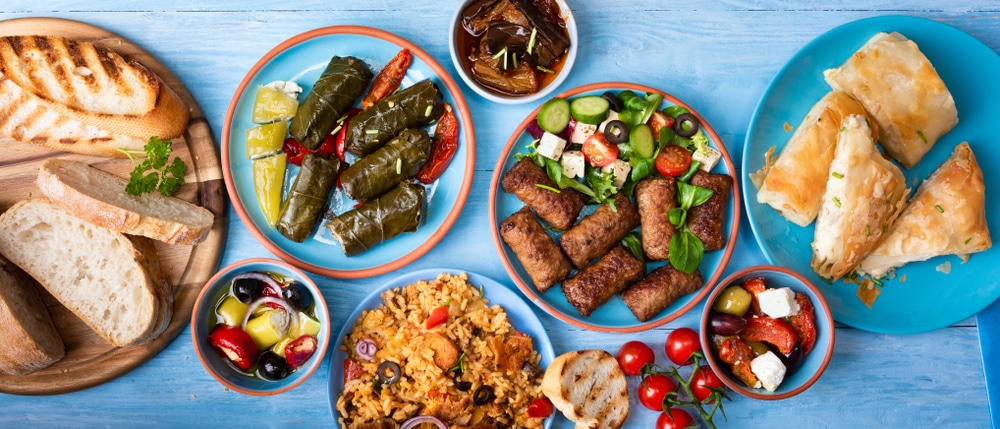 bread, greek pastries, kebeb meats, fresh salad, olives and dips