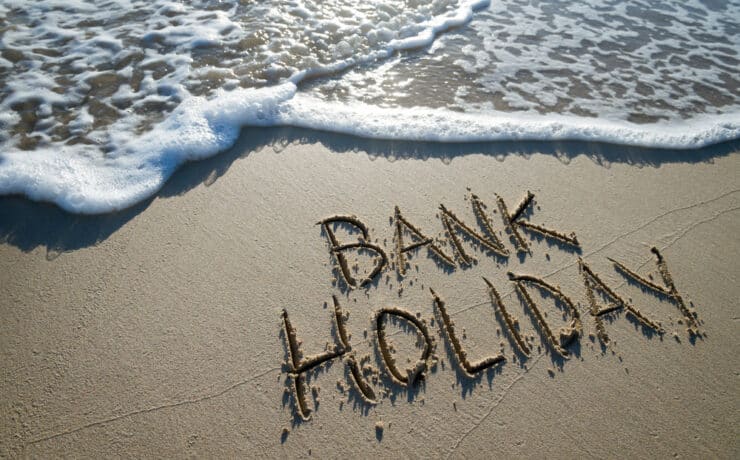 a beach with bank holiday written in the sand