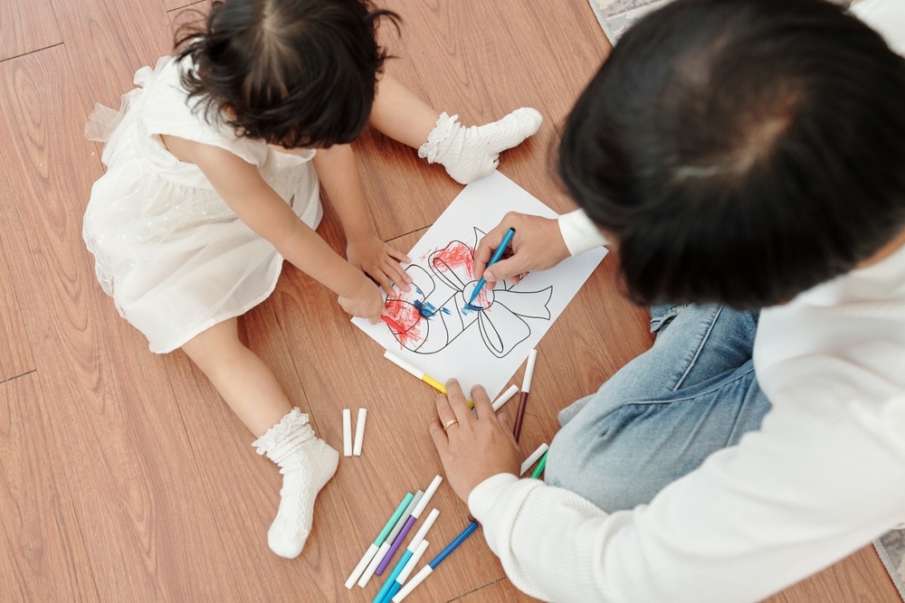 a small child colouring a candy cane in