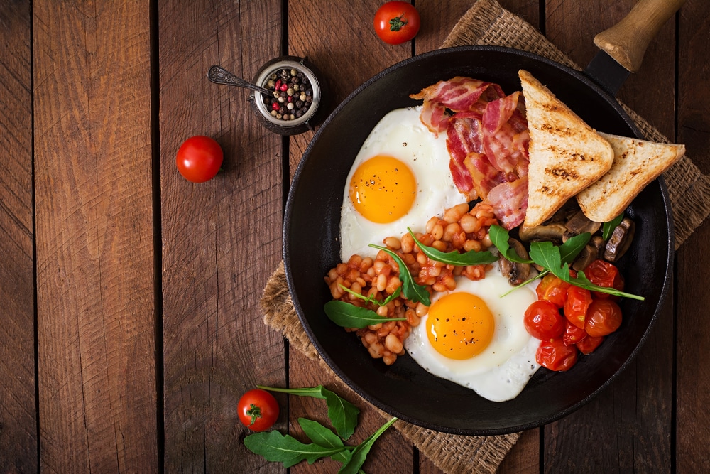 a eggs, toast, spiced beans and tomato breakfast