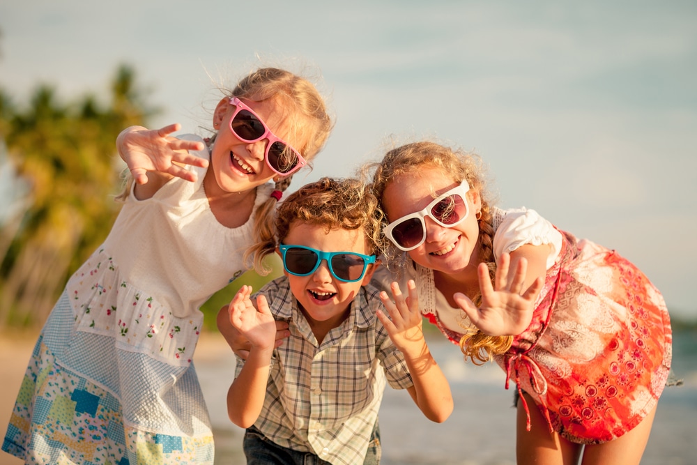 kids on the beach wearing sunglasses