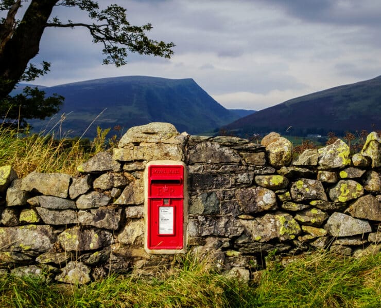 royal mail post box built into wall in rugged countryside