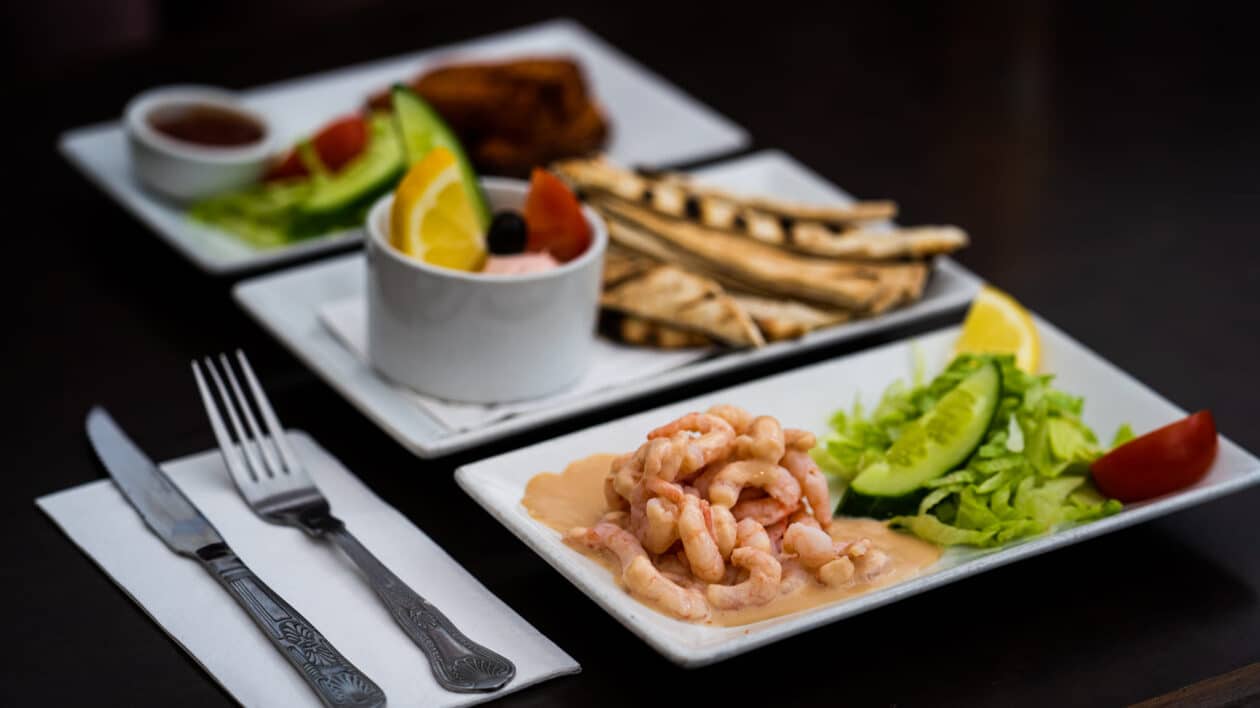 plates of greek food, prawns, aubergine and dips
