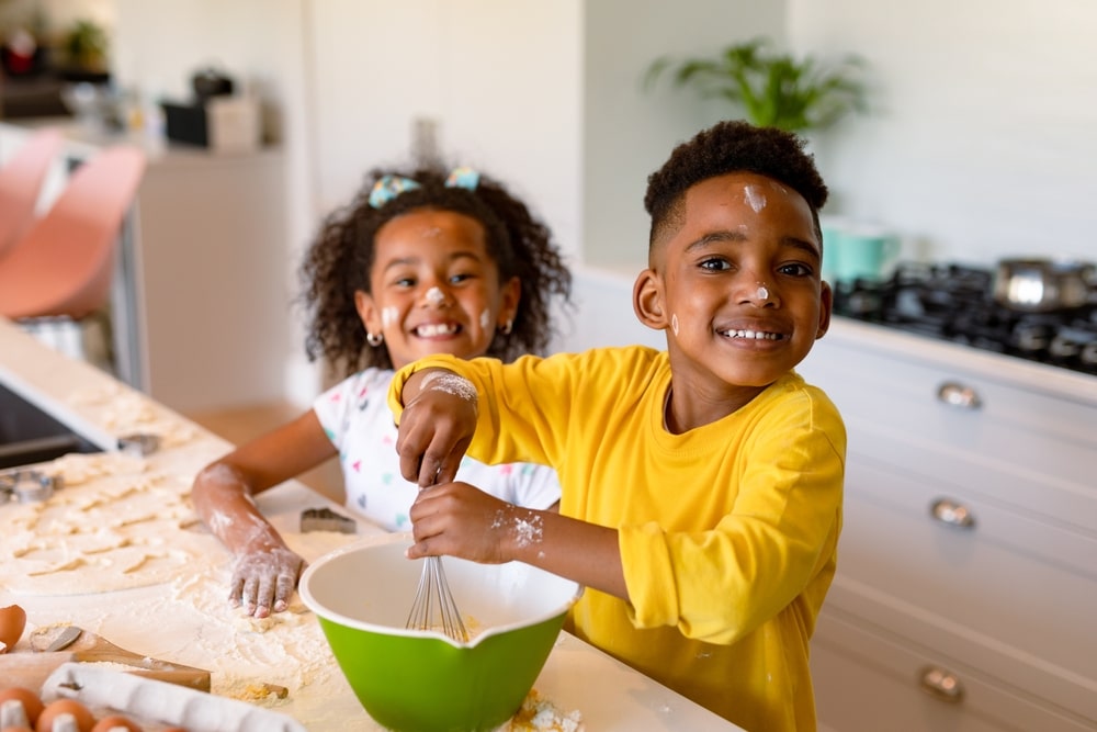 brother and sister baking and laughing.