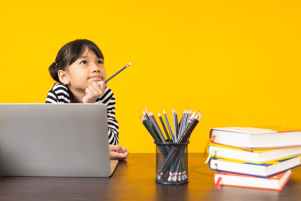 Young girl thinking hard - easy riddles for kids aged 4 to 7