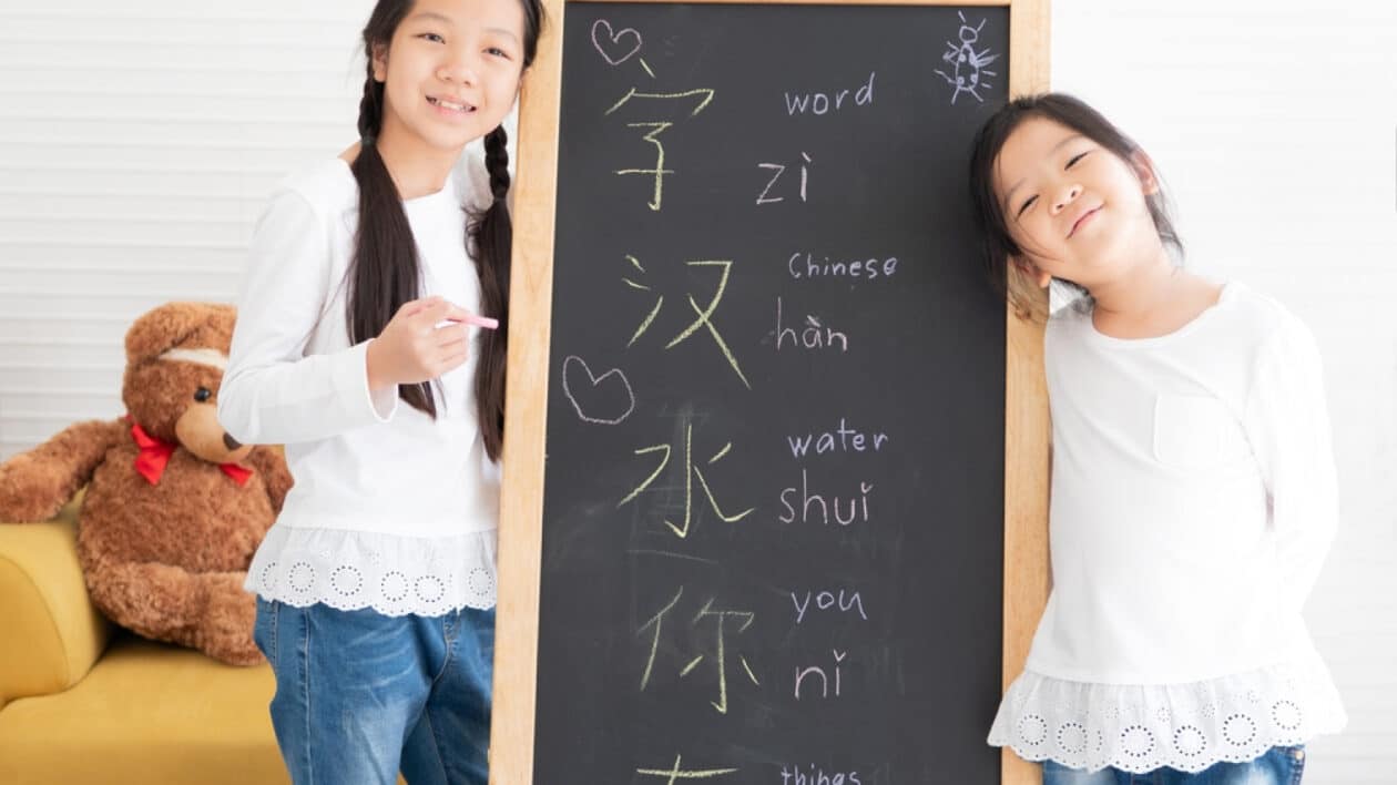 two kids learning how to speak and write in mandarin