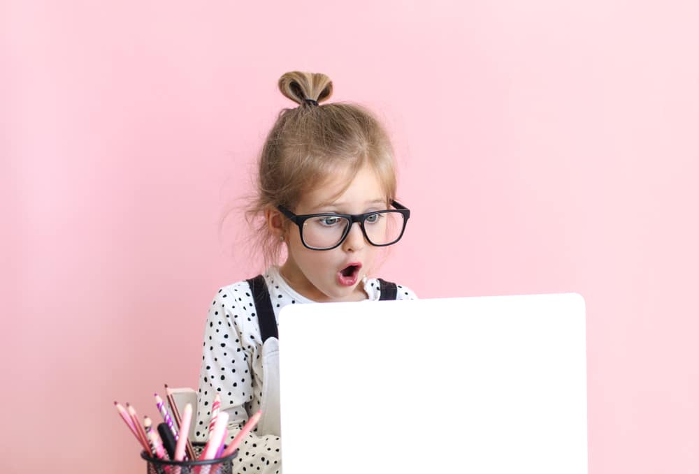 Child working on a laptop - food riddles for kids to try at home