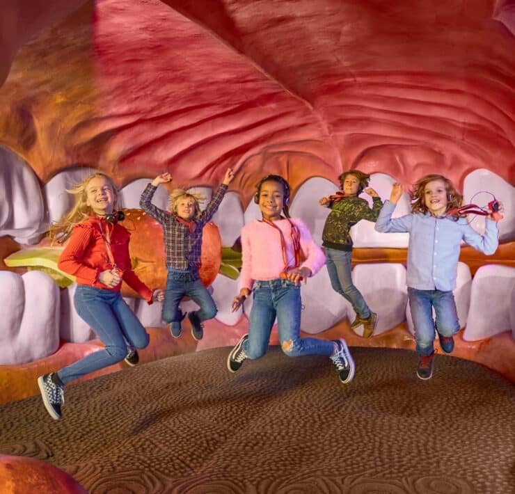 kids bouncing on giant tongue