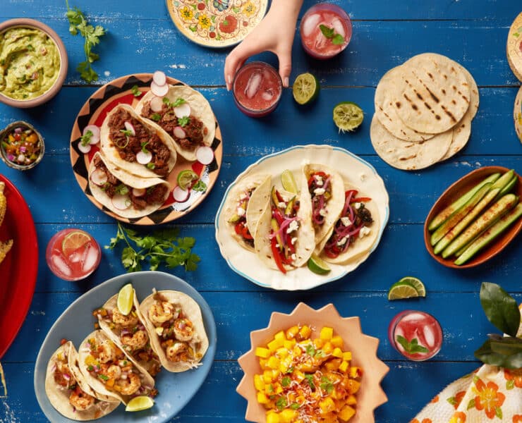 mexican food spread like tacos, burritos and salsa