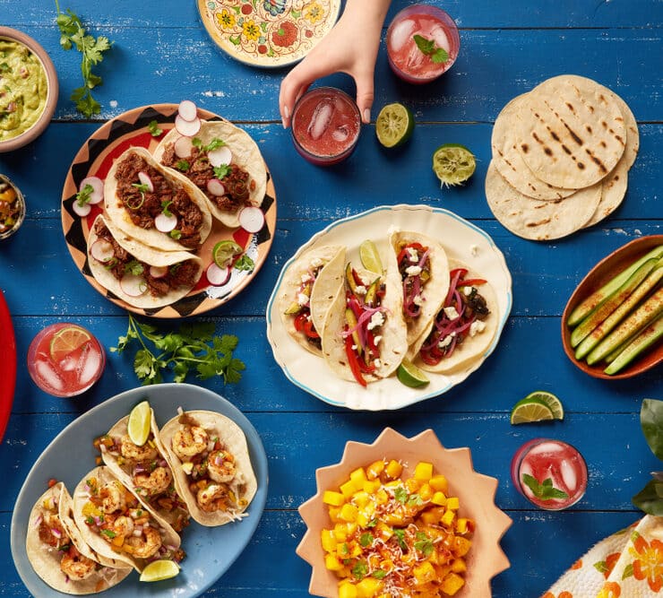 mexican food spread like tacos, burritos and salsa