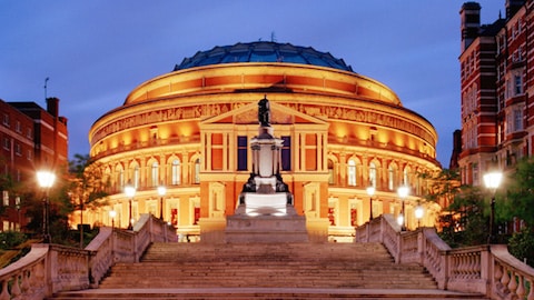 the outside of royal albert hall at night with lights