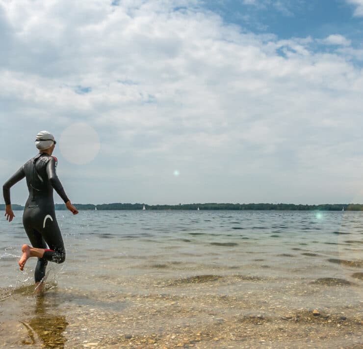 Swimmer entering water outdoors