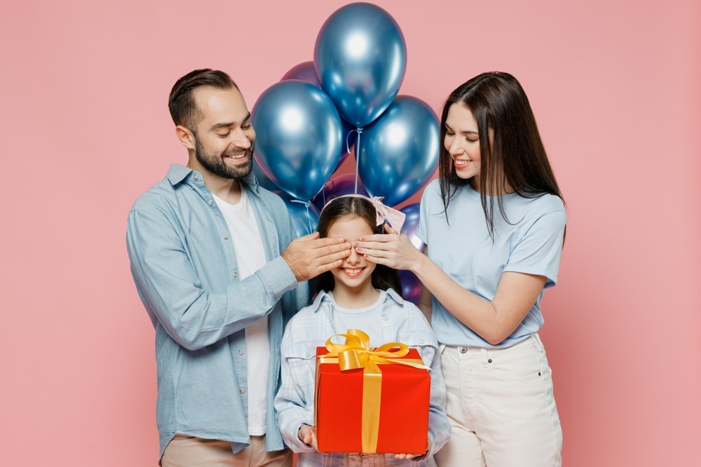 parents covering their childs eyes for a surprise