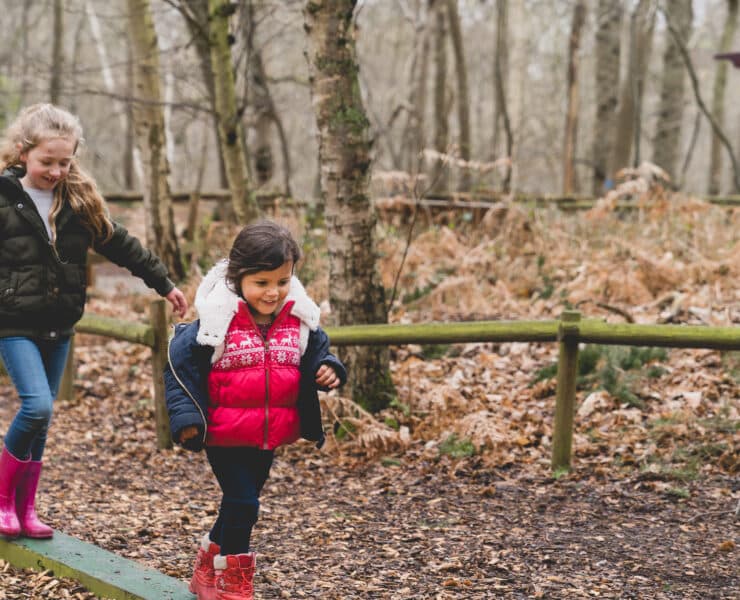 Kids walking through forest adventure playground