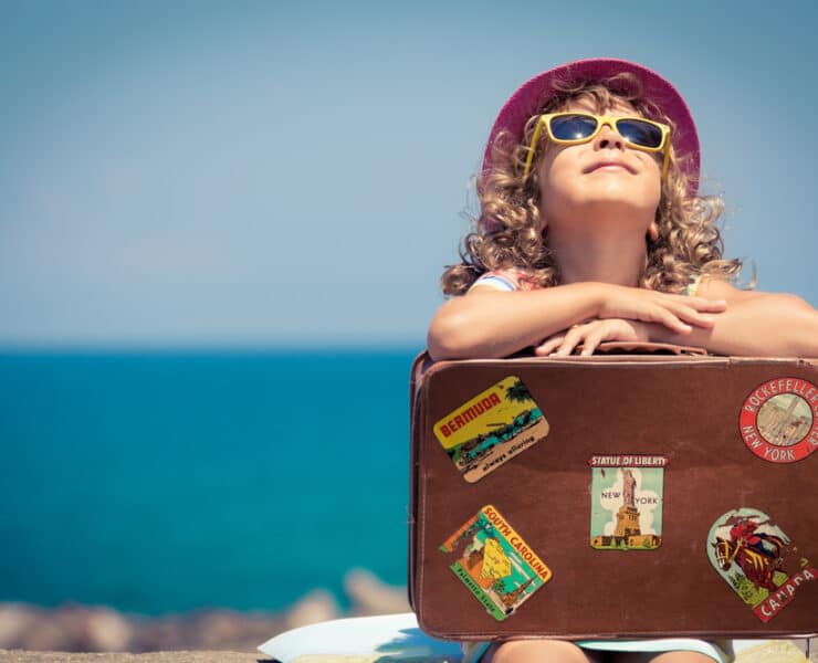 girl resting on a suitcase