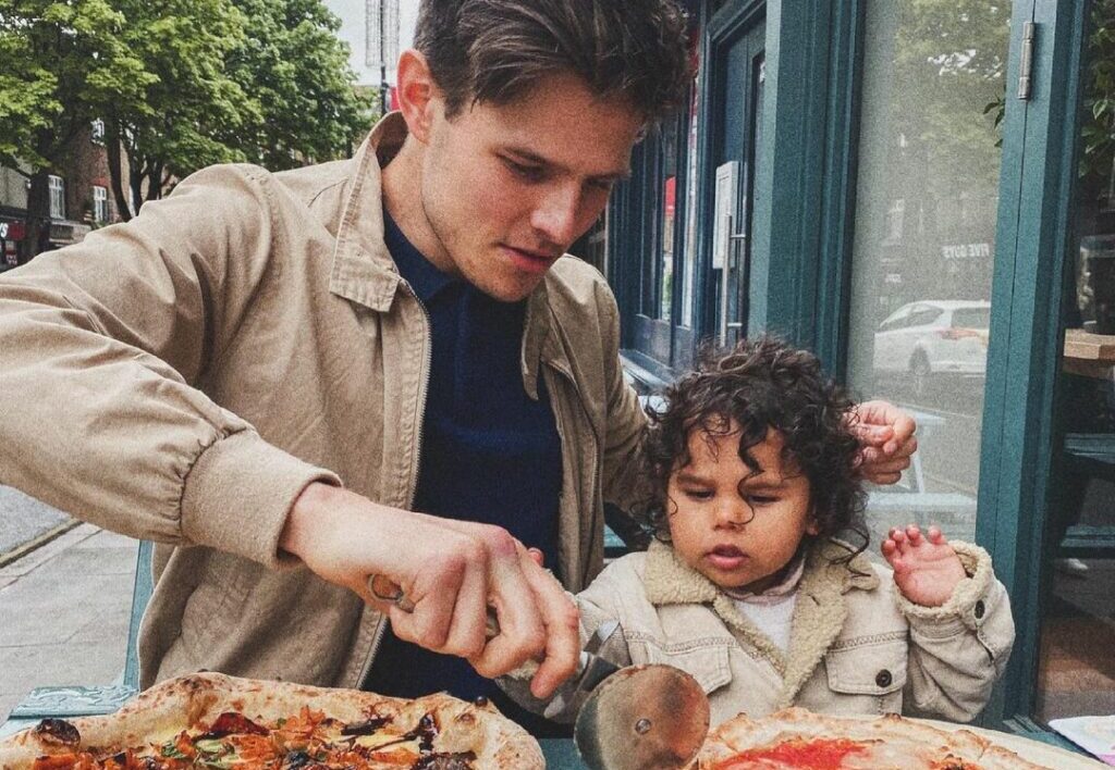 a dad and child eating pizza