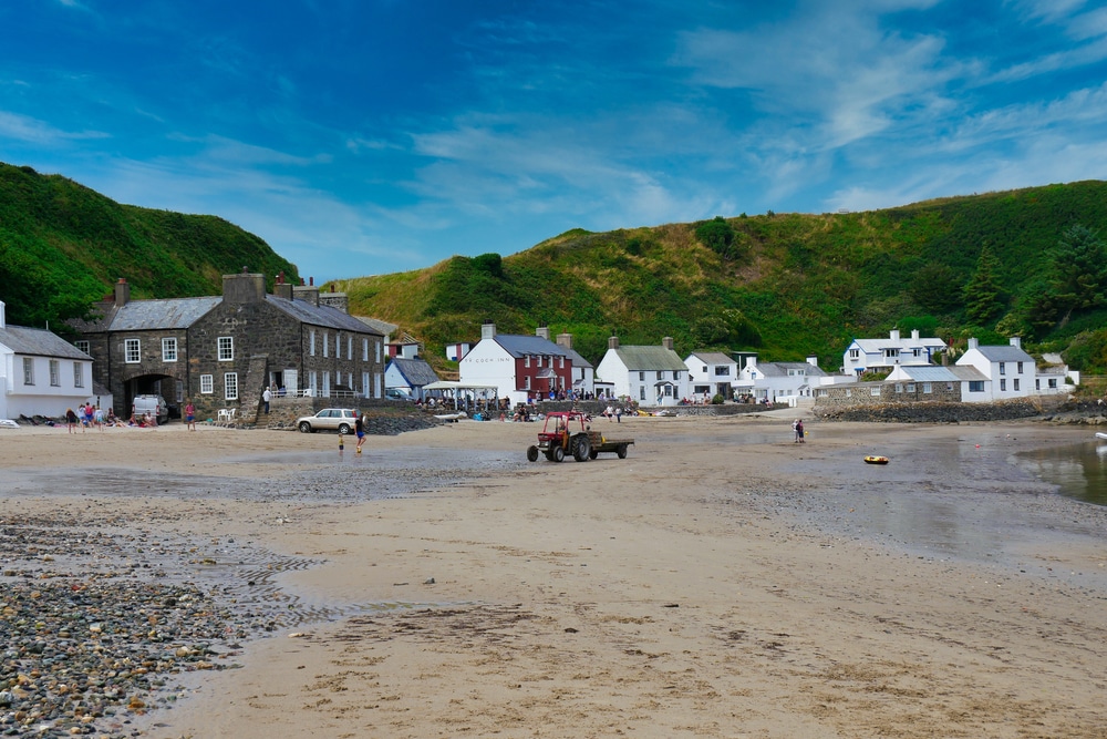 houses along the shoreline at Porthdinllaen beach