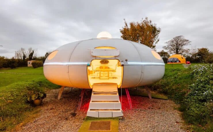 White flying saucer airbnb that's glowing inside.