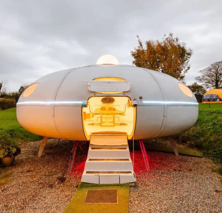 White flying saucer airbnb that's glowing inside.