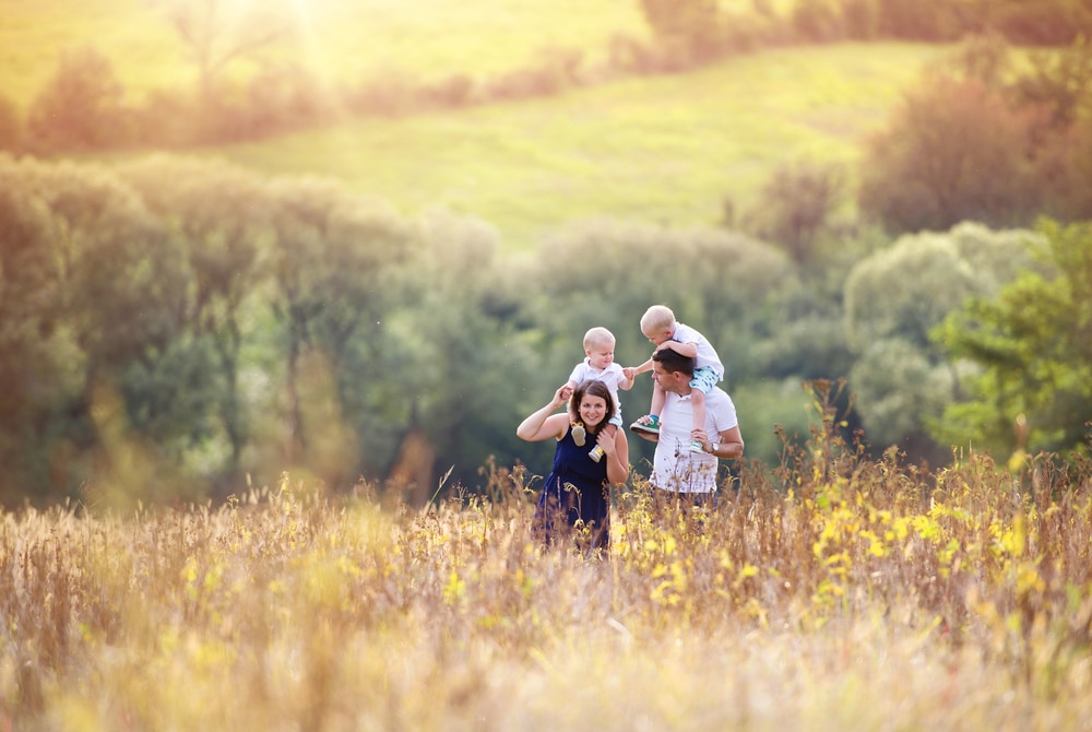family walking through meadow