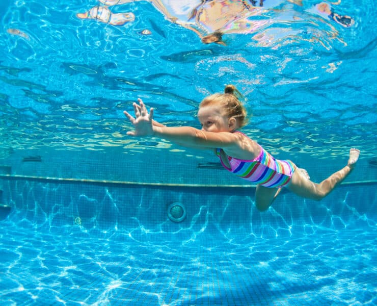 girl swimming under water
