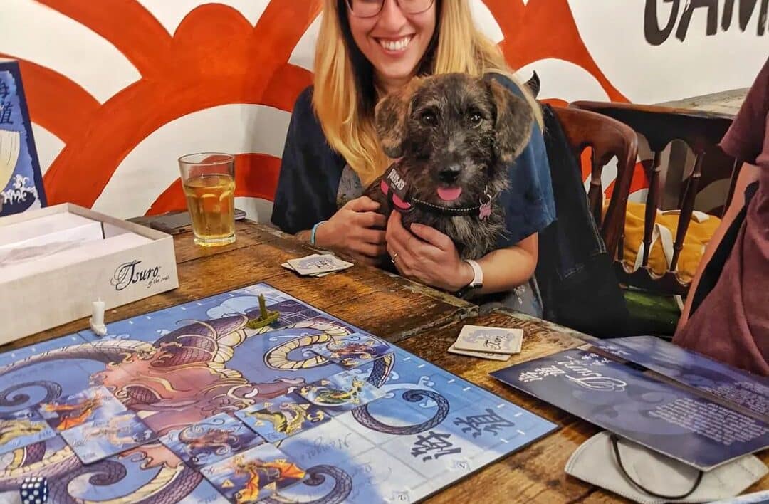 dog on woman's lap in Tanuki Gaming cafe