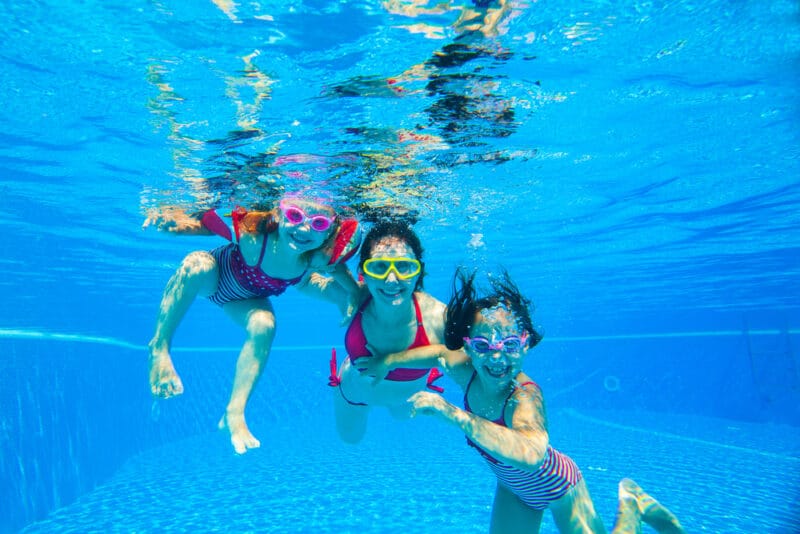 family underwater smiling