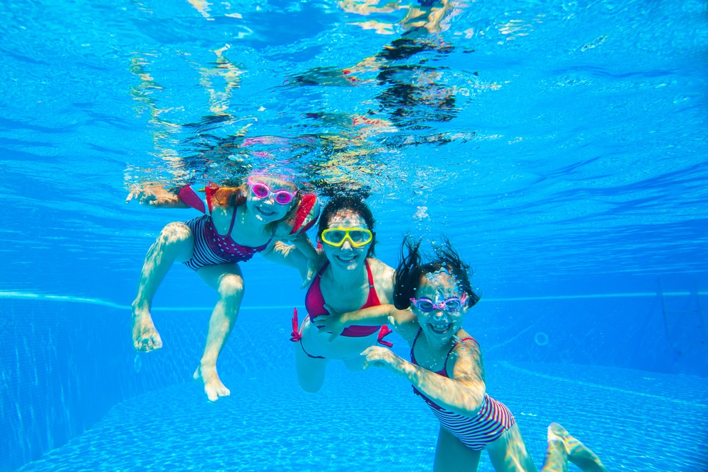 family underwater smiling