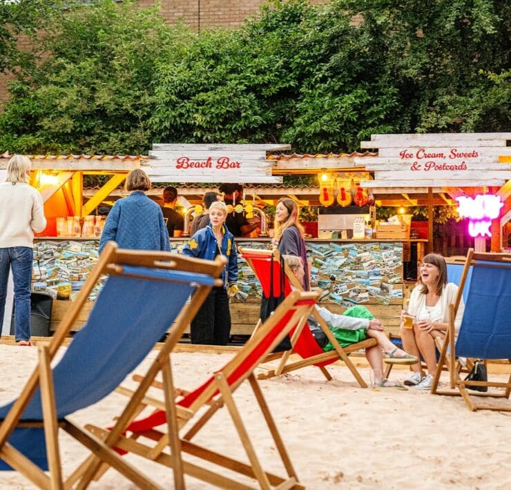 people stood outside of beach shack shops at Walthamstow-On-Sea