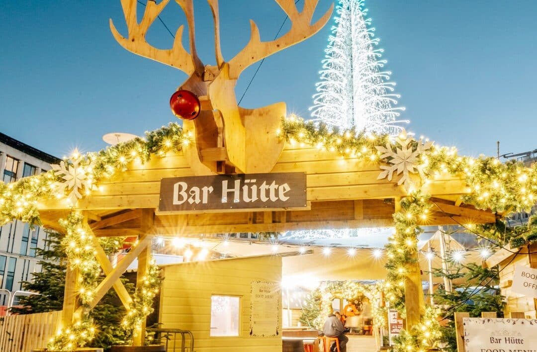wooden alpine hut with reindeer at the front
