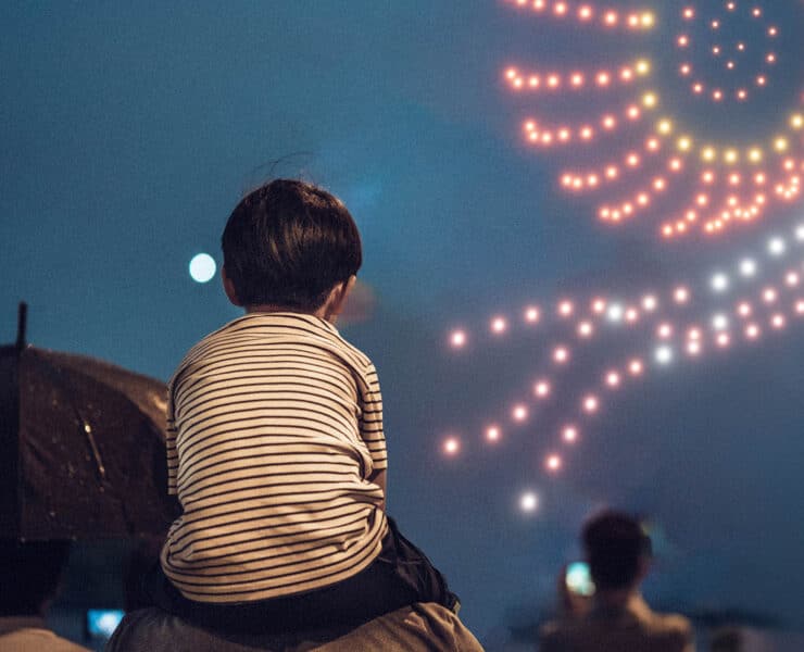 little boy watching a drone show