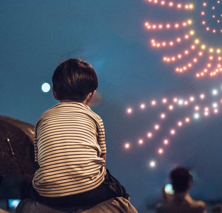 little boy watching a drone show