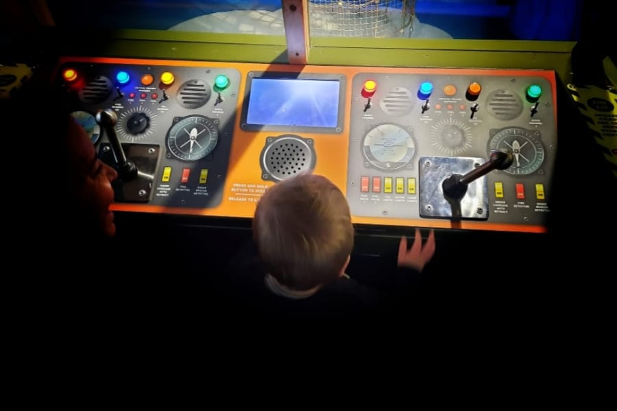boy playing with interactive display