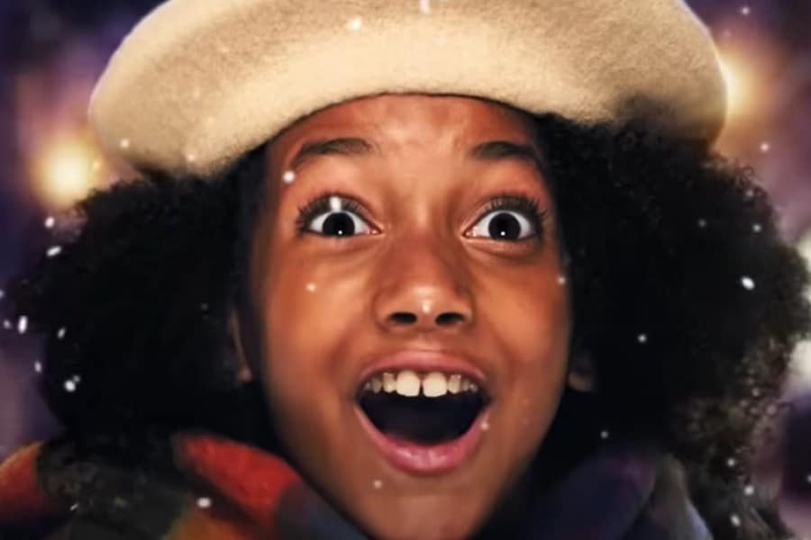an excited girl wearing a christmas hat