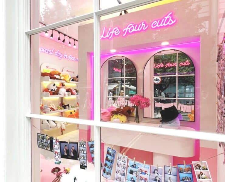 outside view of a Photo Booth with mirrors, props, neon writing and lights