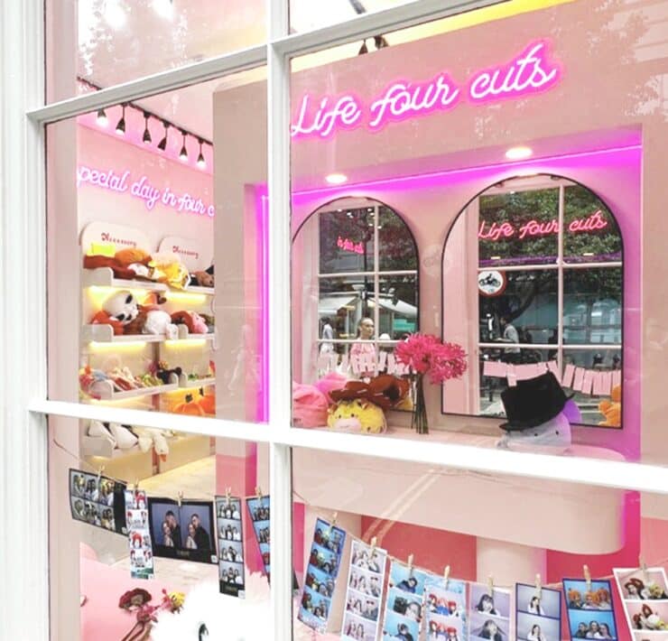 outside view of a Photo Booth with mirrors, props, neon writing and lights