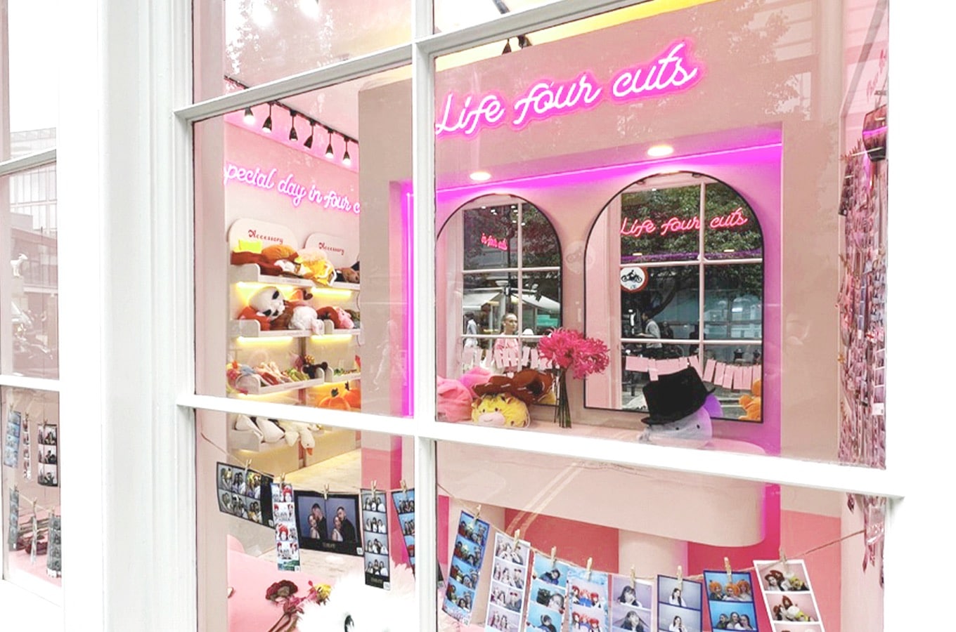 outside view of a Photo Booth with mirrors, props, neon writing and lights