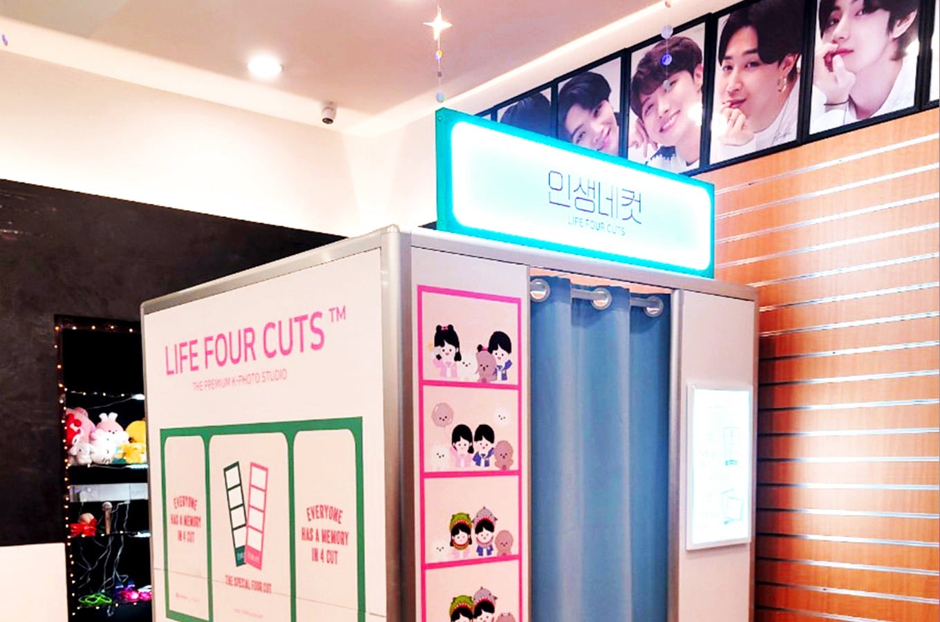 Photo Booth picture with props behind and a neon blue sign