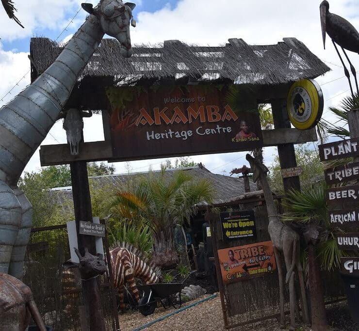 statue of a giraffe in front of the Akamba entrance