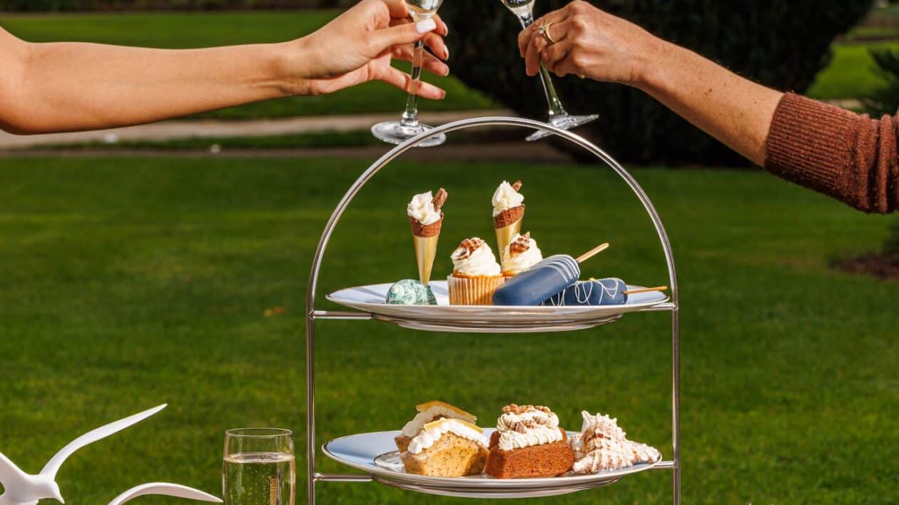 Afternoon tea spread with champagne glasses clinking at Feast on Cloud 9