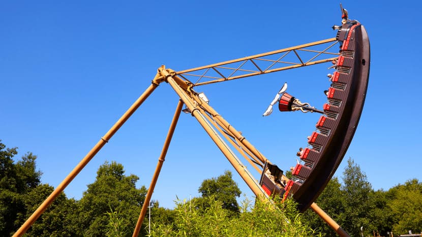 pirate shop swinging in the air surrounded by blue skies and green trees
