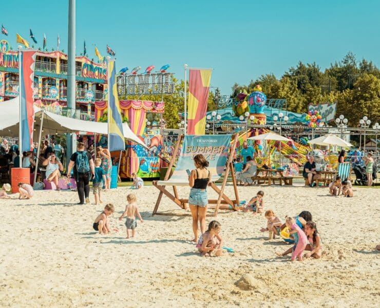 beach at the trafford centre with a large deck chair and bright coloured decorations