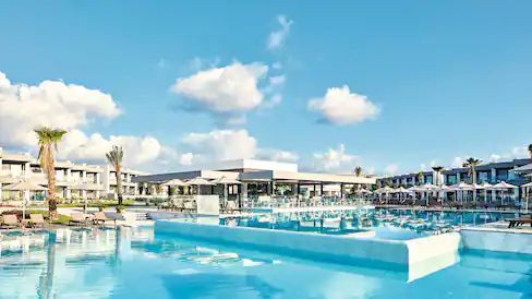 crystal clear pool with holiday resort in the back