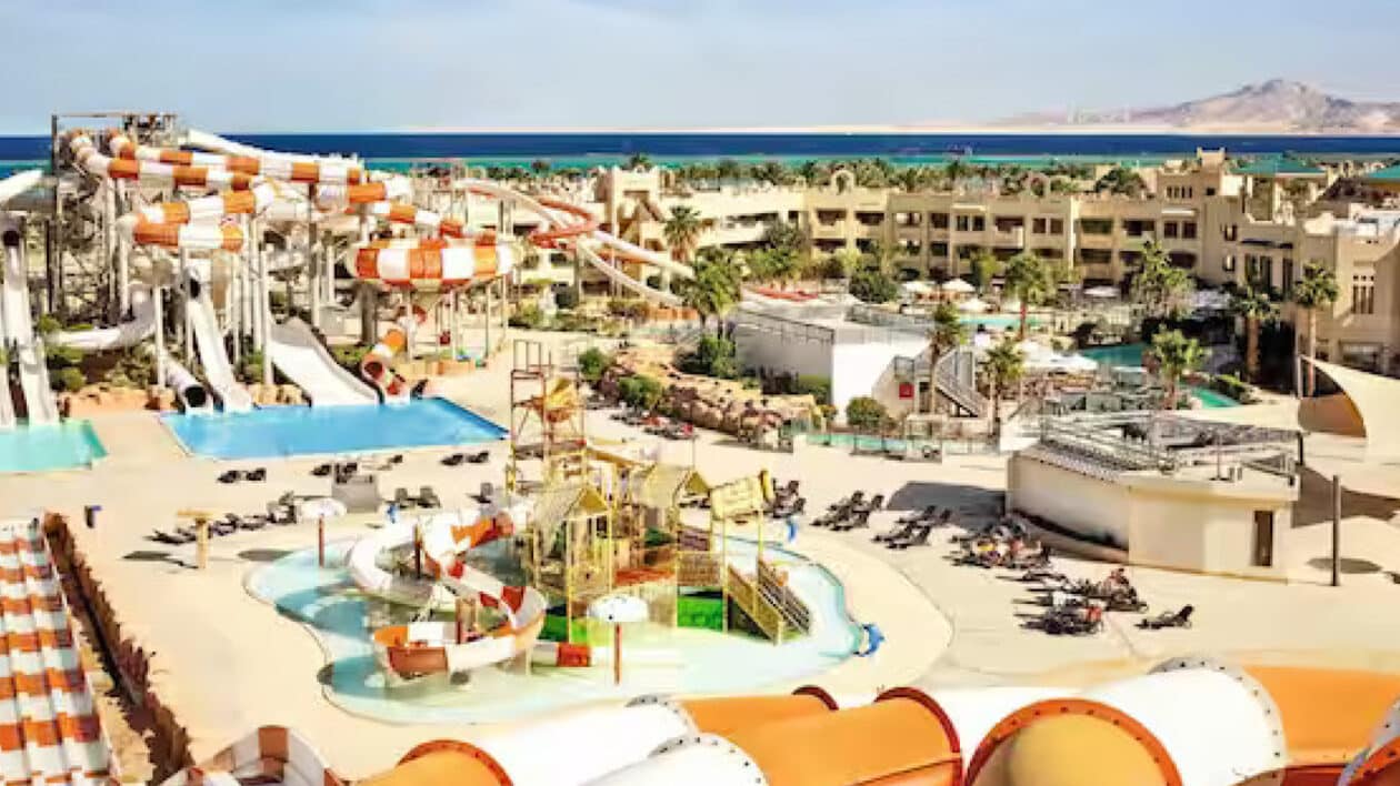 vibrant waterpark with lots of waterslides overlooking the ocean