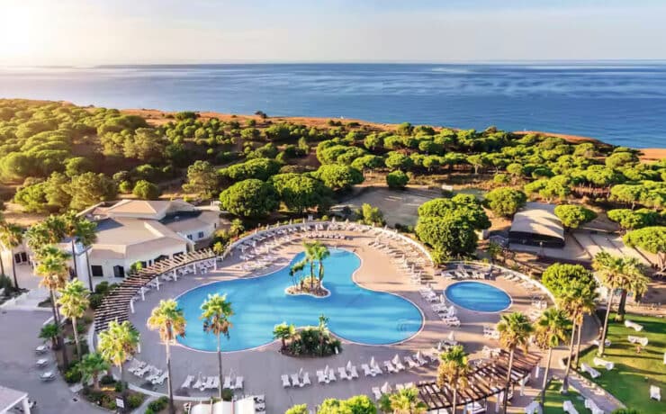 birds eye view of holiday resort with 2 pools, plenty of greenery and the ocean